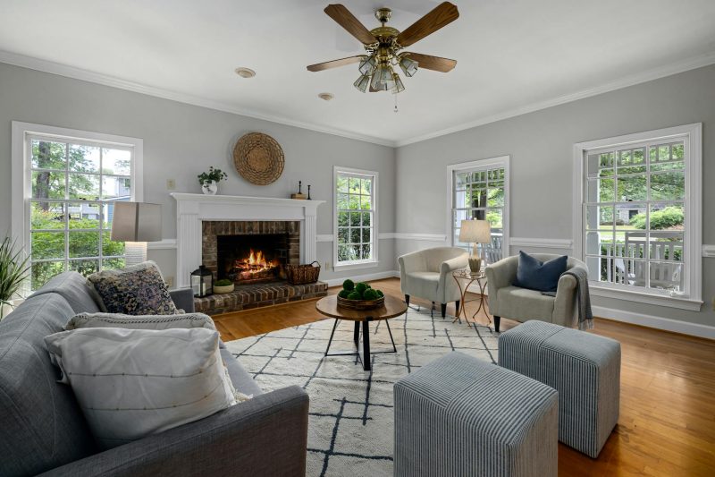 Bright living room with fireplace, modern furniture, and natural light
